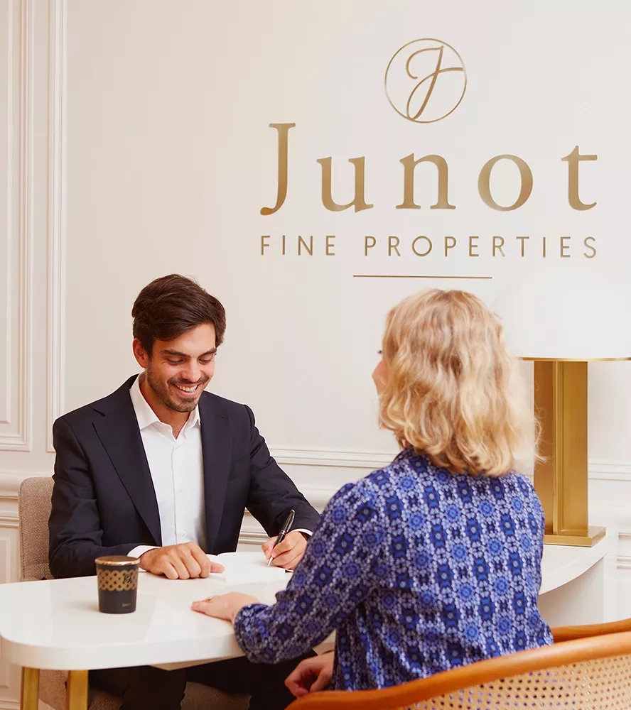 A client seen from behind with a Junot Fine Properties | Knight Frank consultant